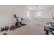 An open loft area featuring exercise equipment and scenic views from multiple windows at 9645 E Ripple Dr, Mesa, AZ 85212