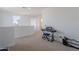 An open loft area with neutral carpet and a comfortable space for a piano at 9645 E Ripple Dr, Mesa, AZ 85212