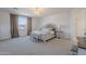 Spacious main bedroom with neutral carpet, large window, and a chandelier at 9645 E Ripple Dr, Mesa, AZ 85212