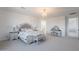 Bright main bedroom with neutral carpet, chandelier, and a vanity with a mirror at 9645 E Ripple Dr, Mesa, AZ 85212