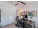 Bright office with a ceiling fan, a dark wood desk, and unique wall decor at 9645 E Ripple Dr, Mesa, AZ 85212
