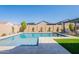 Sparkling pool with baja step, stone pavers, pergola and lush landscaping at 9645 E Ripple Dr, Mesa, AZ 85212