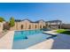 Backyard with a sparkling pool, stone pavers, artificial turf and lush landscaping at 9645 E Ripple Dr, Mesa, AZ 85212