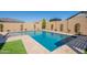 Backyard pool with stone pavers, artificial turf, and lush landscaping at 9645 E Ripple Dr, Mesa, AZ 85212