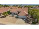Gorgeous home with desert landscaping, a Spanish tile roof, and three-car garage at 10155 E Wood Dr, Scottsdale, AZ 85260