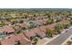 An aerial neighborhood view featuring neat lawns, mature landscaping, and tile roofs under the desert sun at 10155 E Wood Dr, Scottsdale, AZ 85260