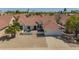 Beautiful home showcasing desert landscaping, a Spanish tile roof, and a two-car garage at 10155 E Wood Dr, Scottsdale, AZ 85260