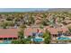 A sprawling neighborhood with mature trees, neat lawns, and tile roofs set against a mountain backdrop at 10155 E Wood Dr, Scottsdale, AZ 85260
