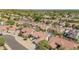A beautiful neighborhood aerial shot with lush green landscaping and well-maintained homes under a clear blue sky at 10155 E Wood Dr, Scottsdale, AZ 85260