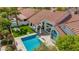 An aerial view of a refreshing backyard pool, green lawn, and comfortable lounge furniture at 10155 E Wood Dr, Scottsdale, AZ 85260