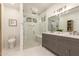 Gorgeous primary bathroom offering a glass shower, double vanity, and modern fixtures at 10155 E Wood Dr, Scottsdale, AZ 85260
