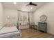 Cozy bedroom with a window seat, neutral walls, and modern furnishings at 10155 E Wood Dr, Scottsdale, AZ 85260