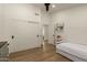 Well-lit bedroom with recessed lighting, light wood floors, and a closet at 10155 E Wood Dr, Scottsdale, AZ 85260