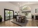 Bright dining room boasts a modern table, large windows, sleek lighting, and seamless access to the backyard at 10155 E Wood Dr, Scottsdale, AZ 85260