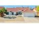 Charming single-story home boasts a manicured front yard, tile roof, and a spacious three-car garage at 10155 E Wood Dr, Scottsdale, AZ 85260