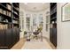 Comfortable home office with built-in shelving, a large window, and plenty of natural light for work at 10155 E Wood Dr, Scottsdale, AZ 85260