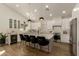 Modern kitchen with white cabinets, an island with counter seating, and stainless-steel appliances provides ample workspace at 10155 E Wood Dr, Scottsdale, AZ 85260