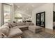 Spacious living room features a large sectional sofa, vaulted ceiling, and natural light from oversized windows at 10155 E Wood Dr, Scottsdale, AZ 85260