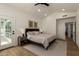 Bright main bedroom featuring vaulted ceiling, recessed lighting, and light wood floors at 10155 E Wood Dr, Scottsdale, AZ 85260