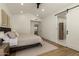 Bright main bedroom boasting recessed lights, ceiling fan, and an en suite bathroom at 10155 E Wood Dr, Scottsdale, AZ 85260
