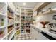 Organized walk-in pantry with custom shelves, countertop space, and ample storage for all your needs at 10155 E Wood Dr, Scottsdale, AZ 85260