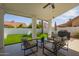 Covered patio featuring ample seating area and backyard views with lush turf at 10155 E Wood Dr, Scottsdale, AZ 85260