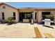 Charming back patio featuring stone pavers, outdoor furniture, and a built-in grill at 10572 E Autumn Sage Dr, Scottsdale, AZ 85255
