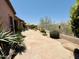 A backyard patio with desert landscaping, decorative rocks, and wrought-iron fencing at 10572 E Autumn Sage Dr, Scottsdale, AZ 85255