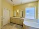 Bright bathroom features dual sinks, a large soaking tub, and modern fixtures at 10572 E Autumn Sage Dr, Scottsdale, AZ 85255