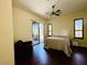Charming bedroom featuring hardwood floors and sliding glass doors to the patio at 10572 E Autumn Sage Dr, Scottsdale, AZ 85255