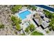 Aerial view of a community pool, surrounding landscaping, and clubhouse at 10572 E Autumn Sage Dr, Scottsdale, AZ 85255