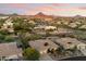 Expansive aerial view showcases the property's lush landscaping, desert surroundings, and beautiful mountain backdrop at 11193 N 121St Way, Scottsdale, AZ 85259