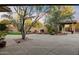 Beautiful backyard featuring a desert landscape, a built-in stone fire pit with ample seating and outdoor kitchen area at 11193 N 121St Way, Scottsdale, AZ 85259