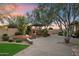 Serene backyard showcasing fire pit with stone seating, desert landscaping, and relaxing pergola at 11193 N 121St Way, Scottsdale, AZ 85259