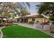 Backyard with large grass area, firepit, and built in grill at 11193 N 121St Way, Scottsdale, AZ 85259