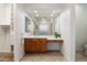 Bathroom features a sink with brown cabinets, drawers, and a large framed mirror at 11193 N 121St Way, Scottsdale, AZ 85259