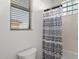 Bathroom features a shower with patterned curtain and window at 11193 N 121St Way, Scottsdale, AZ 85259
