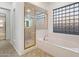 Bright bathroom featuring a combined shower and bathtub with gold trim at 11193 N 121St Way, Scottsdale, AZ 85259