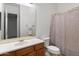 Bathroom features a single sink vanity and shower with curtain at 11193 N 121St Way, Scottsdale, AZ 85259