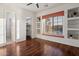Bedroom featuring hardwood floors, built-in shelving, and window seating at 11193 N 121St Way, Scottsdale, AZ 85259
