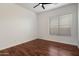 This bedroom has wood floors and a ceiling fan at 11193 N 121St Way, Scottsdale, AZ 85259