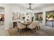 Elegant dining area with modern chandelier, seating for six, and view of the outdoor space at 11193 N 121St Way, Scottsdale, AZ 85259