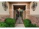 Inviting entryway with an iron gate and stone pathway, leading to a beautifully landscaped courtyard at 11193 N 121St Way, Scottsdale, AZ 85259