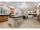 Open concept kitchen with wood cabinets, island seating, and seamless flow to the living area at 11193 N 121St Way, Scottsdale, AZ 85259