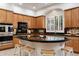 Well-equipped kitchen with dark countertops, a tile backsplash, and barstool seating at 11193 N 121St Way, Scottsdale, AZ 85259