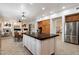Spacious kitchen island with dark countertop, connecting to the living and dining spaces at 11193 N 121St Way, Scottsdale, AZ 85259