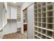 Spacious walk-in closet leading to bathroom vanity with built-in storage and shelving at 11193 N 121St Way, Scottsdale, AZ 85259