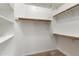 Walk-in closet featuring wood rods and shelving at 11193 N 121St Way, Scottsdale, AZ 85259