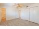 Bedroom boasts wood-look floors, a ceiling fan, closet, and adjacent bathroom at 1124 S Longwood Loop, Mesa, AZ 85208