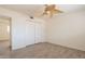 Bedroom featuring wood-look floors, a ceiling fan, and a closet at 1124 S Longwood Loop, Mesa, AZ 85208